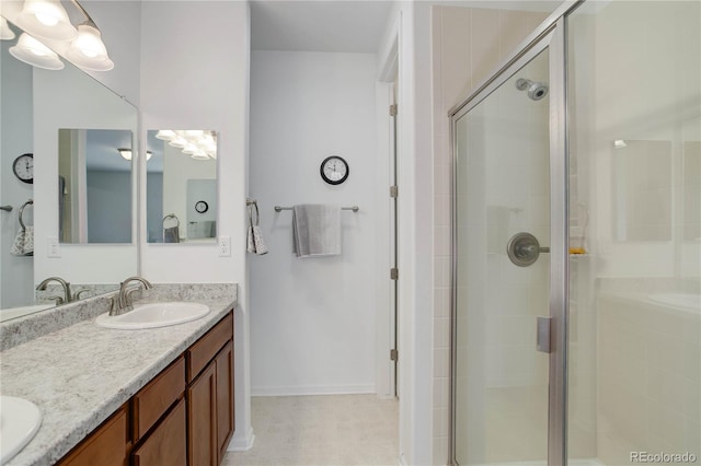 9643 Birch Ln, Thornton, CO 80229 - bathroom with double vanity, a stall shower, and baseboards