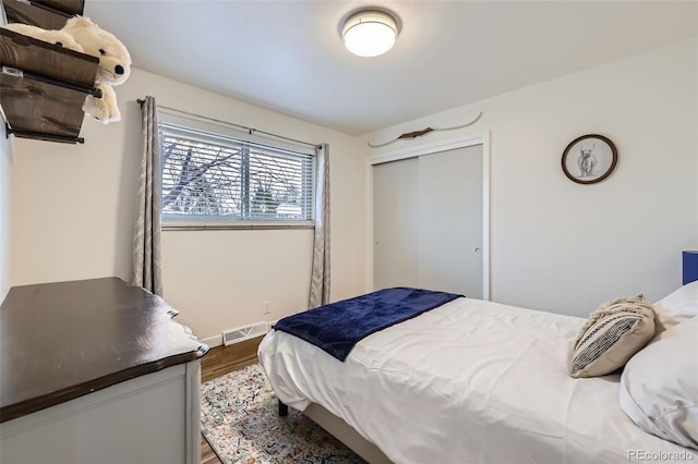 bedroom featuring hardwood / wood-style floors and a closet