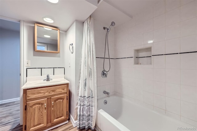 bathroom featuring vanity, hardwood / wood-style flooring, and shower / bathtub combination with curtain