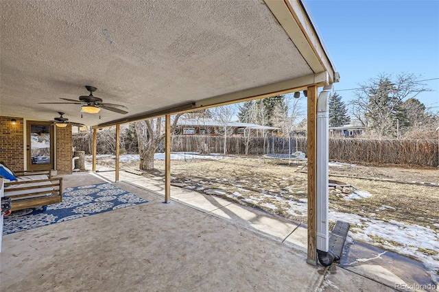 snow covered patio featuring ceiling fan