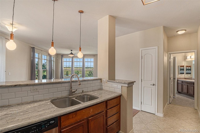 13456 Via Varra Unit 140, Broomfield, CO 80020 - kitchen featuring dishwasher, healthy amount of natural light, light tile patterned floors, and brown cabinets