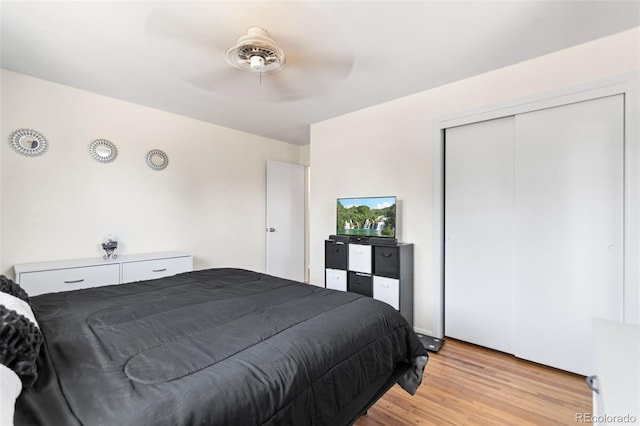 3397 W Tanforan Dr, Englewood, CO 80110 - bedroom with light wood-style flooring, a closet, and a ceiling fan