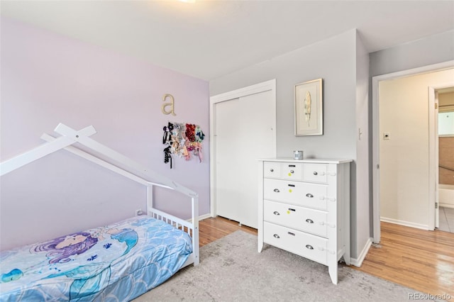 3397 W Tanforan Dr, Englewood, CO 80110 - bedroom with light wood finished floors and a closet