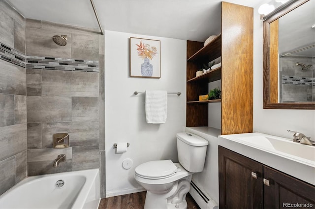 full bathroom with hardwood / wood-style floors, tiled shower / bath combo, vanity, baseboard heating, and toilet