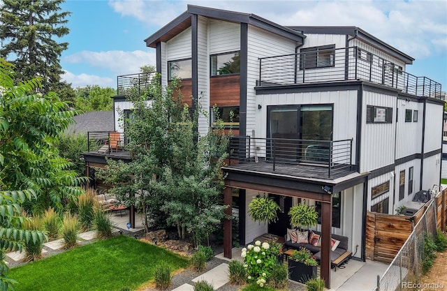 2147 S Sherman St, Denver, CO 80210 - view of front of home with a balcony, a patio area, and outdoor lounge area