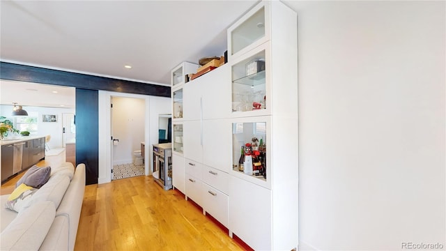 2147 S Sherman St, Denver, CO 80210 - kitchen featuring white cabinetry, light wood finished floors, open floor plan, glass insert cabinets, and recessed lighting