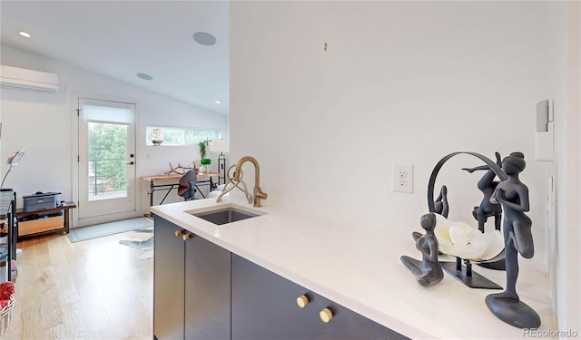 2147 S Sherman St, Denver, CO 80210 - kitchen featuring vaulted ceiling, a wall unit AC, light wood-style floors, light countertops, and recessed lighting
