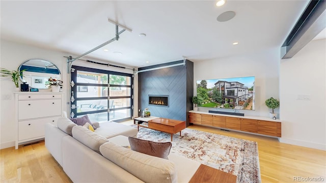 2147 S Sherman St, Denver, CO 80210 - living area with light wood-type flooring, a fireplace, and recessed lighting