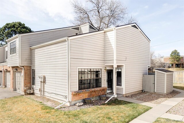 exterior space featuring a lawn, concrete driveway, and fence