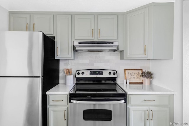 kitchen with light countertops, exhaust hood, backsplash, and stainless steel appliances