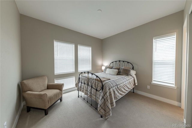 bedroom featuring light colored carpet