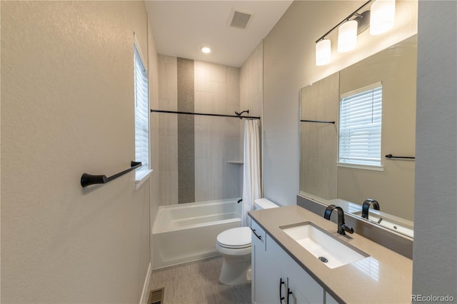 full bathroom featuring toilet, vanity, and shower / tub combo