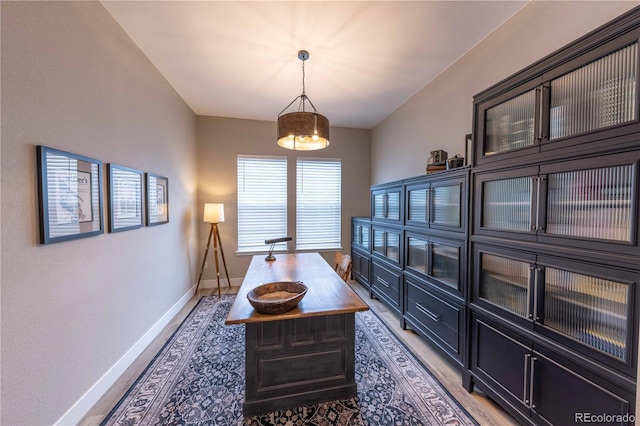 office area with baseboards and wood finished floors