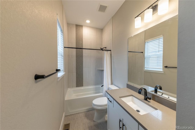 full bath featuring visible vents, bathing tub / shower combination, toilet, and vanity