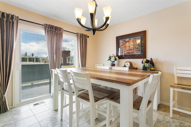 3338 Soaring Bird Cir, Colorado Springs, CO 80920 - dining area with baseboards, visible vents, and a chandelier
