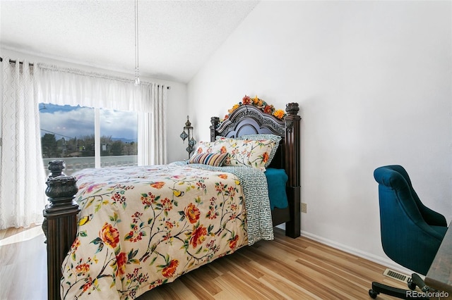 3338 Soaring Bird Cir, Colorado Springs, CO 80920 - bedroom featuring baseboards, visible vents, wood finished floors, and vaulted ceiling