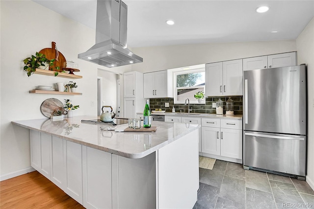 4781 S Grant St, Englewood, CO 80113 - kitchen featuring freestanding refrigerator, island range hood, a sink, open shelves, and a peninsula