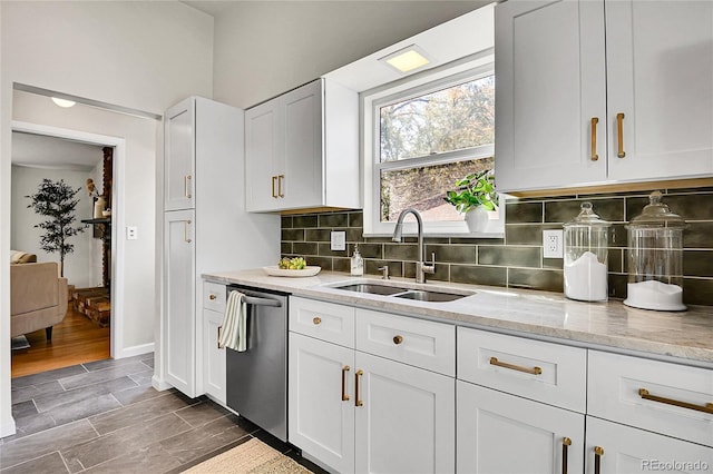 4781 S Grant St, Englewood, CO 80113 - kitchen featuring a sink, dishwasher, white cabinetry, light stone countertops, and decorative backsplash