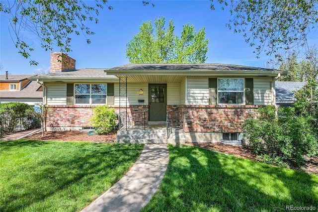 4781 S Grant St, Englewood, CO 80113 - view of front of property featuring brick siding, a front yard, covered porch, and a chimney