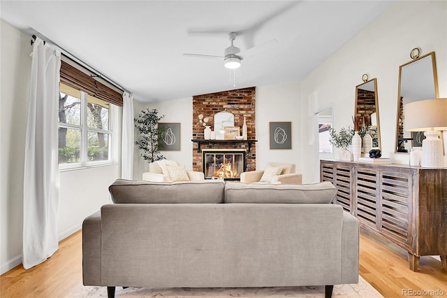 4781 S Grant St, Englewood, CO 80113 - living room with vaulted ceiling, a ceiling fan, a brick fireplace, and light wood-style floors