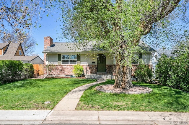 4781 S Grant St, Englewood, CO 80113 - view of front of home featuring a chimney, brick siding, and a porch