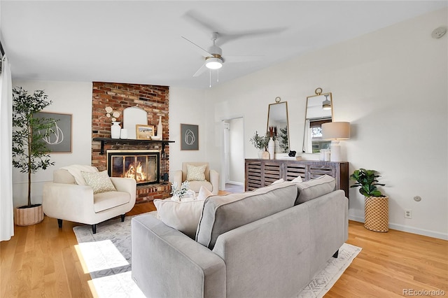 4781 S Grant St, Englewood, CO 80113 - living room with light wood-style floors, a ceiling fan, a brick fireplace, and baseboards