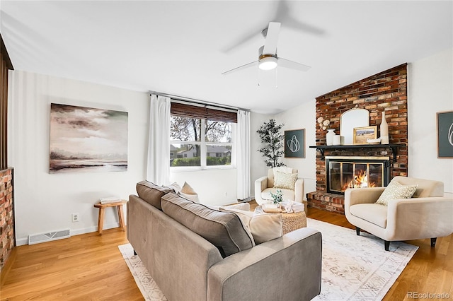 4781 S Grant St, Englewood, CO 80113 - living room with a fireplace, light wood-style floors, a ceiling fan, and vaulted ceiling