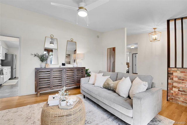 4781 S Grant St, Englewood, CO 80113 - living area with light wood-style flooring, a ceiling fan, and a chandelier
