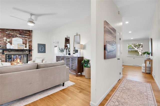 4781 S Grant St, Englewood, CO 80113 - living room with light wood-type flooring, ceiling fan, a brick fireplace, baseboards, and recessed lighting