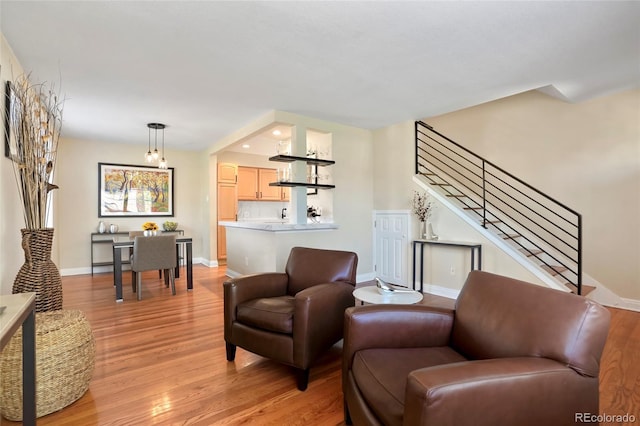 2813 Jasmine St, Denver, CO 80207 - living area with light wood-style flooring, baseboards, and stairway