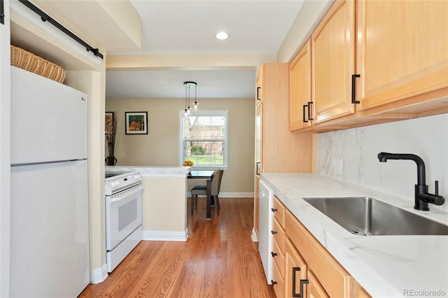 2813 Jasmine St, Denver, CO 80207 - kitchen featuring white appliances, light brown cabinetry, a sink, light wood-style flooring, and recessed lighting