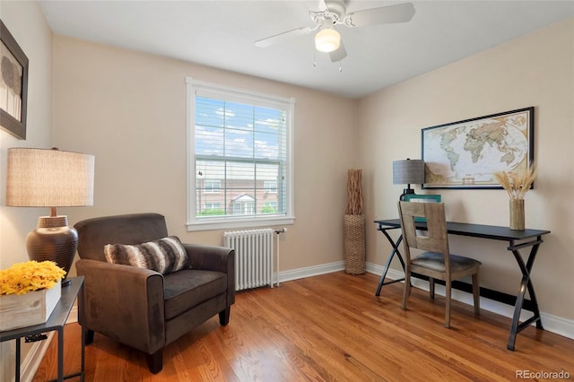 2813 Jasmine St, Denver, CO 80207 - living area featuring radiator, wood finished floors, a ceiling fan, and baseboards