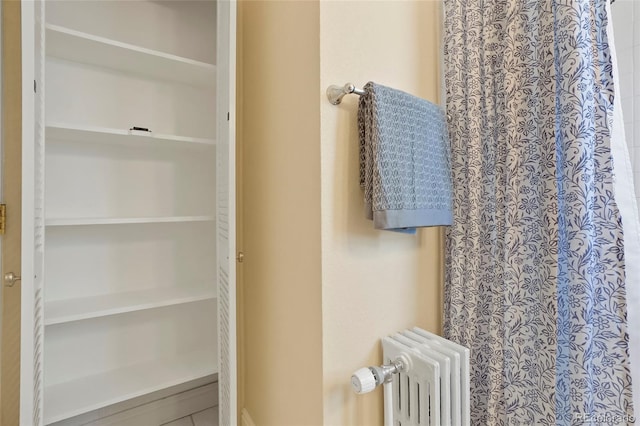2813 Jasmine St, Denver, CO 80207 - full bathroom with radiator heating unit and curtained shower