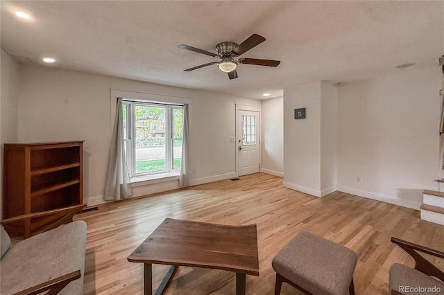 117 Sandler Dr, Lafayette, CO 80026 - living room featuring a ceiling fan, light wood-style floors, baseboards, a textured ceiling, and recessed lighting