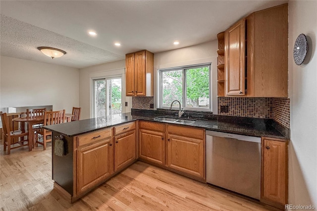 117 Sandler Dr, Lafayette, CO 80026 - kitchen featuring stainless steel dishwasher, a sink, light wood finished floors, decorative backsplash, and recessed lighting