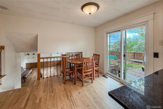 117 Sandler Dr, Lafayette, CO 80026 - dining area featuring light wood-style floors and a textured ceiling