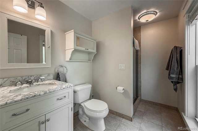117 Sandler Dr, Lafayette, CO 80026 - bathroom featuring vanity, toilet, a shower stall, baseboards, and tile patterned floors