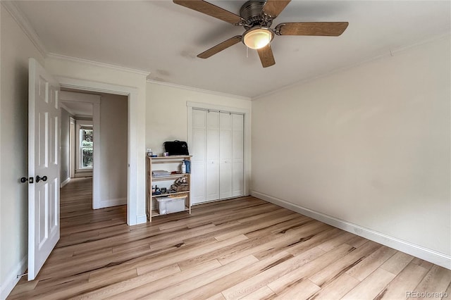 117 Sandler Dr, Lafayette, CO 80026 - unfurnished bedroom featuring light wood finished floors, baseboards, crown molding, a closet, and a ceiling fan