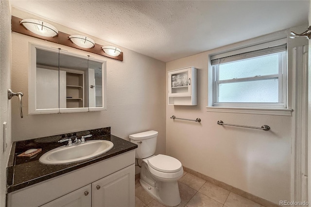 117 Sandler Dr, Lafayette, CO 80026 - bathroom with vanity, tile patterned flooring, toilet, a textured ceiling, and baseboards