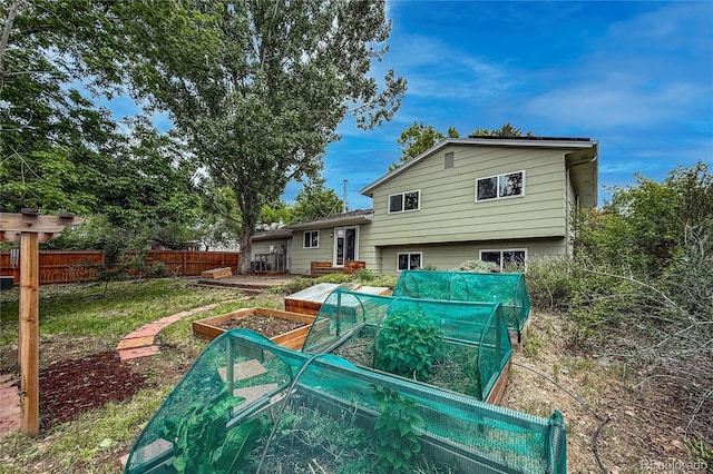 117 Sandler Dr, Lafayette, CO 80026 - rear view of house with a vegetable garden