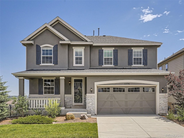11096 Endeavor Dr, Parker, CO 80134 - view of front of house featuring covered porch, an attached garage, driveway, stucco siding, and stone siding