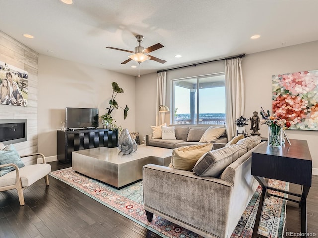 11096 Endeavor Dr, Parker, CO 80134 - living room featuring a ceiling fan, wood finished floors, recessed lighting, baseboards, and a large fireplace