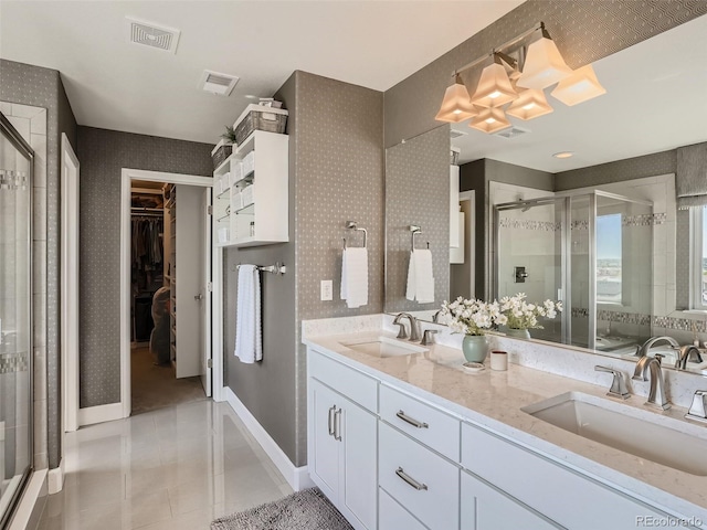 11096 Endeavor Dr, Parker, CO 80134 - bathroom featuring a shower stall, double vanity, tile patterned flooring, and a walk in closet