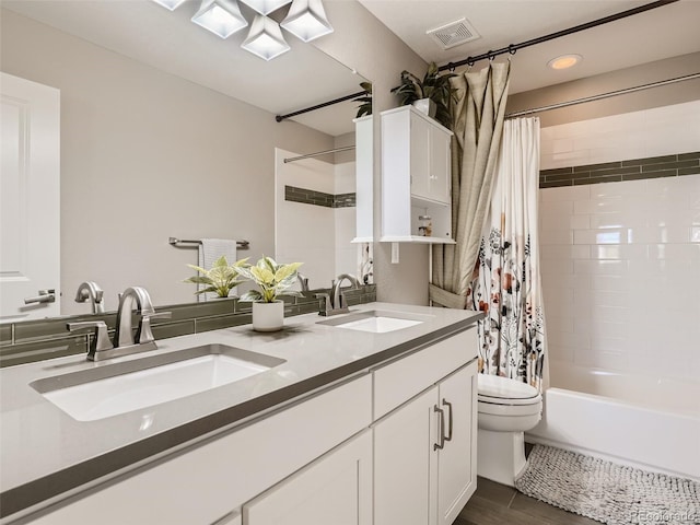 11096 Endeavor Dr, Parker, CO 80134 - full bathroom featuring shower / bath combo, double vanity, toilet, recessed lighting, and wood finished floors