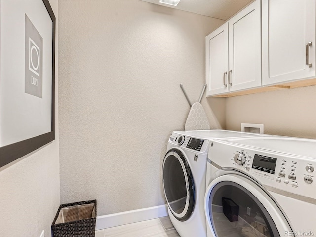 11096 Endeavor Dr, Parker, CO 80134 - washroom featuring washing machine and clothes dryer, cabinet space, a textured wall, and baseboards
