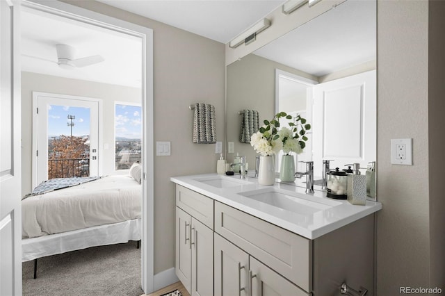 full bathroom with ensuite bath, a sink, and double vanity