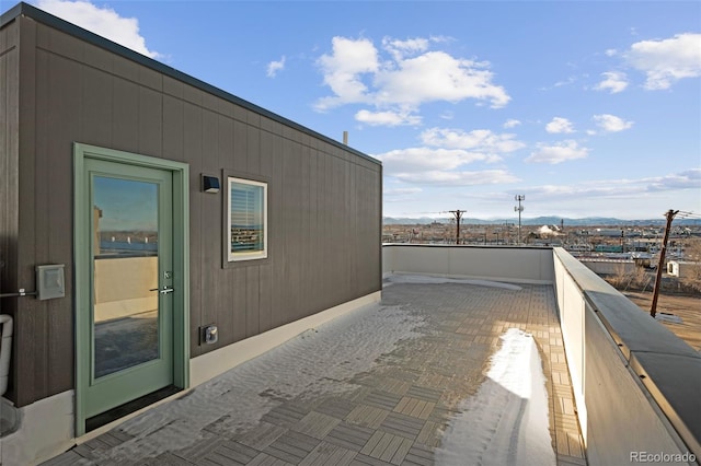 view of patio featuring a mountain view and a balcony
