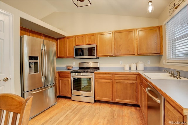 12671 Meadow Bridge Way, Parker, CO 80134 - kitchen with appliances with stainless steel finishes, a sink, lofted ceiling, light countertops, and light wood-style floors