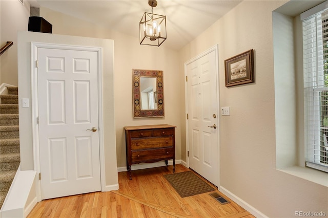 12671 Meadow Bridge Way, Parker, CO 80134 - entryway with stairs, light wood-style flooring, a chandelier, and baseboards