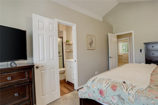 12671 Meadow Bridge Way, Parker, CO 80134 - bedroom featuring vaulted ceiling, connected bathroom, wood finished floors, and baseboards
